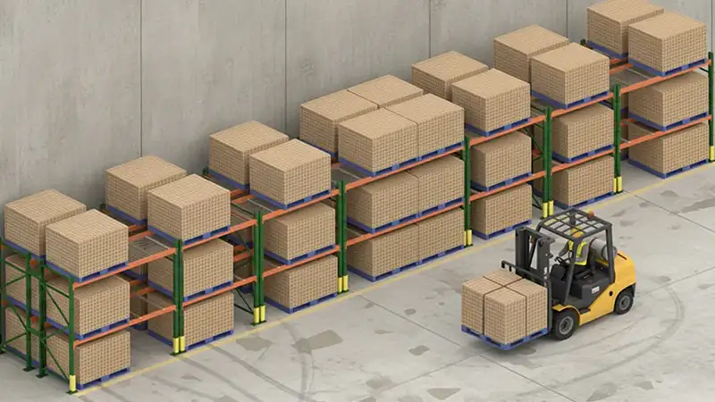 Selective pallet racking organized against a warehouse wall.